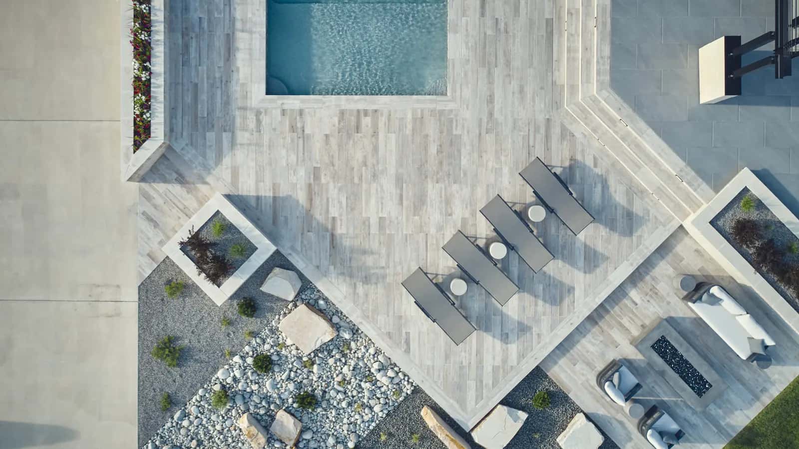 Overhead view of a completed custom pool, spa, and porcelain paver deck at a Colorado Front Range home