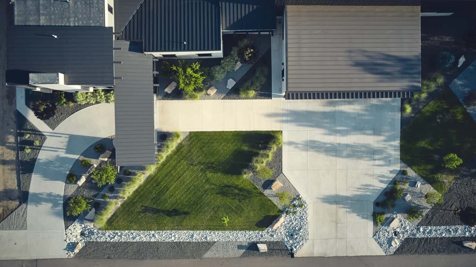 Aerial view of a Colorado Front Range property showing house, drive, lawn panels, and surrounding lot boundaries