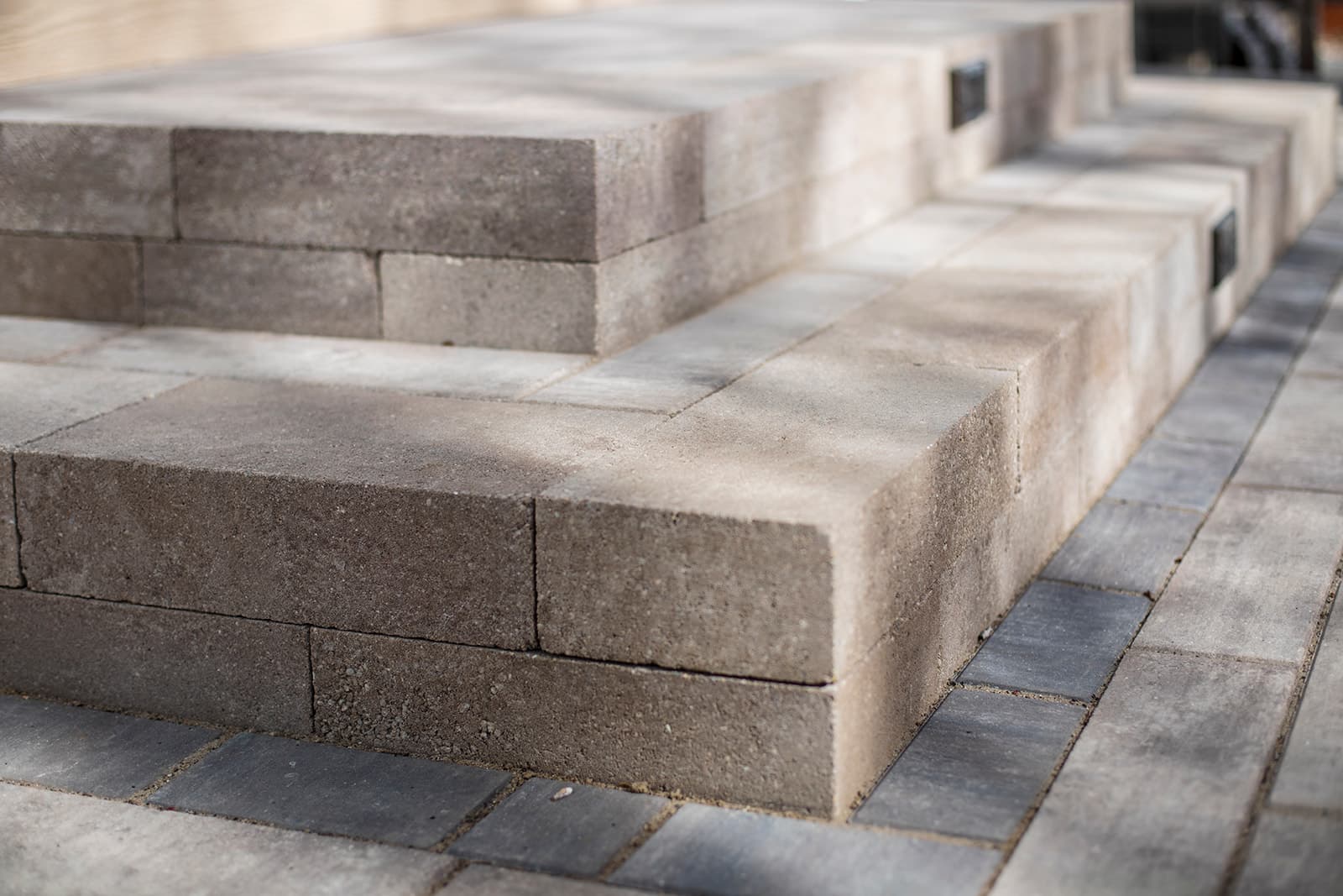 Outdoor living space with paver patio and landscape lighting in Longmont, Colorado