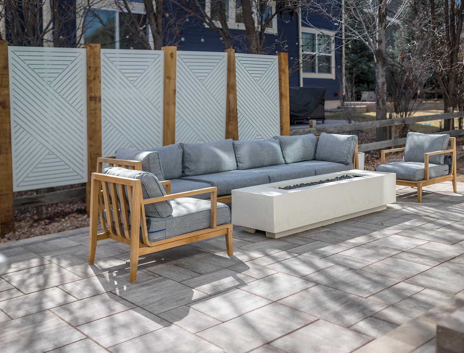 Natural stone patio with custom fire pit and retaining wall in Boulder, Colorado