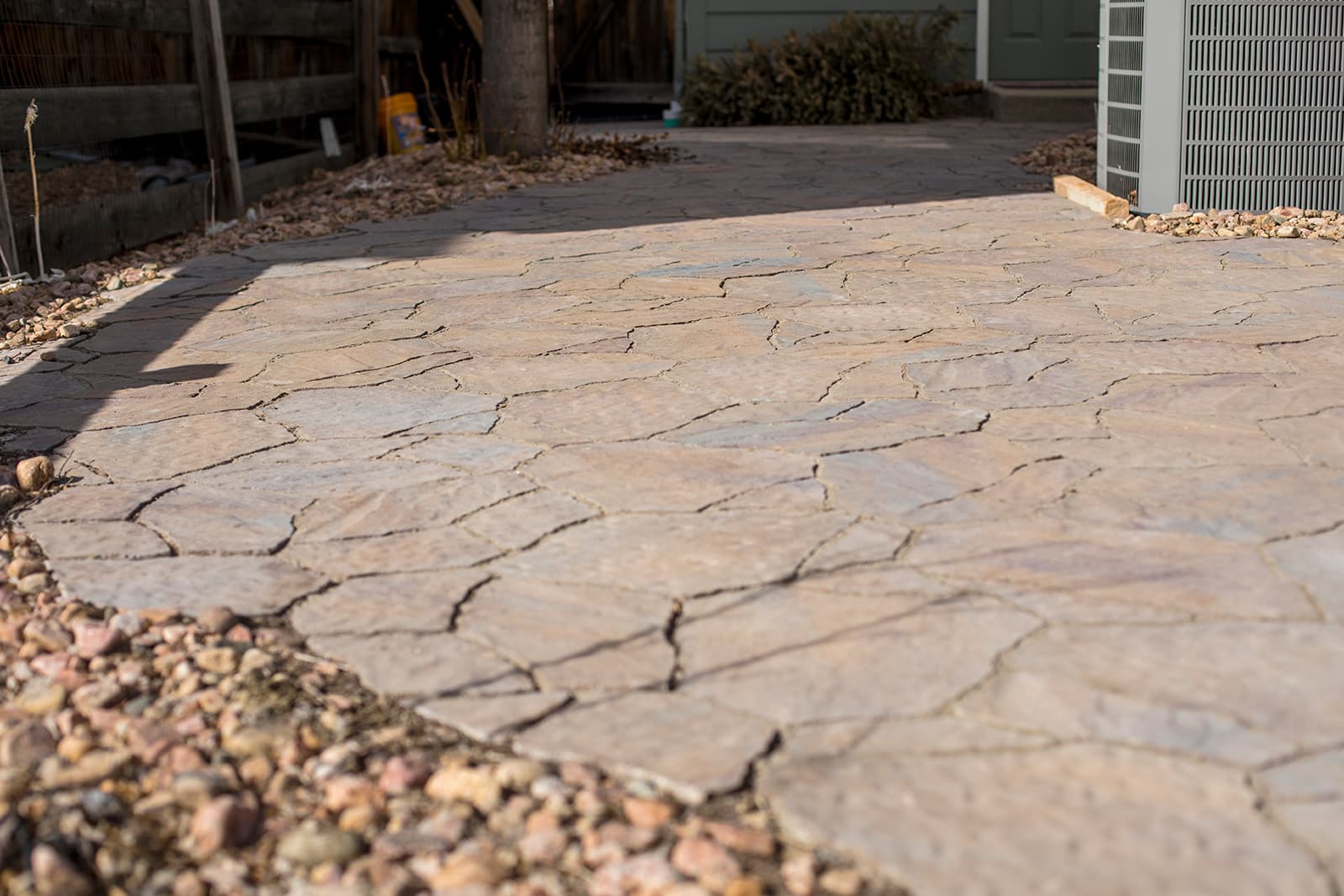 Custom paver patio with built-in fire feature and seating area in Lafayette, Colorado